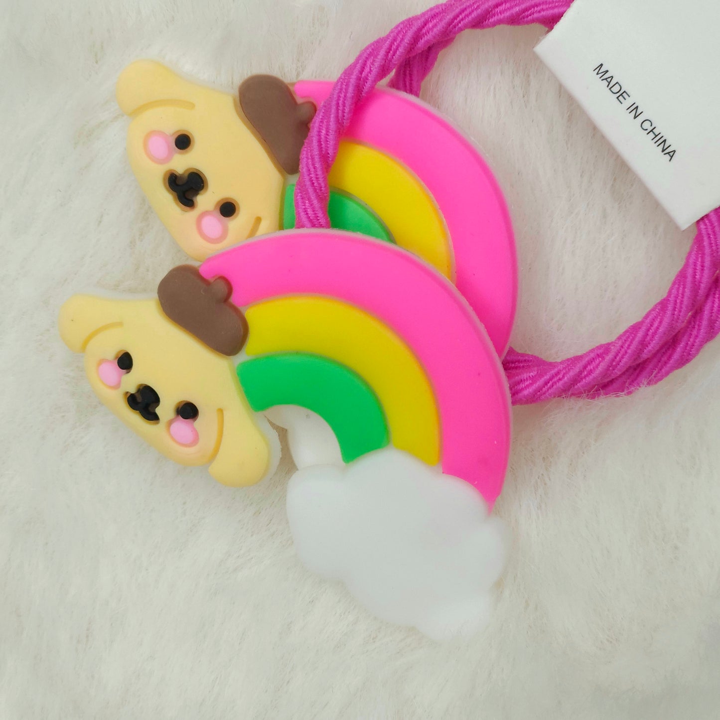 Two colorful hair ties with cartoon dog and rainbow design on a white background.