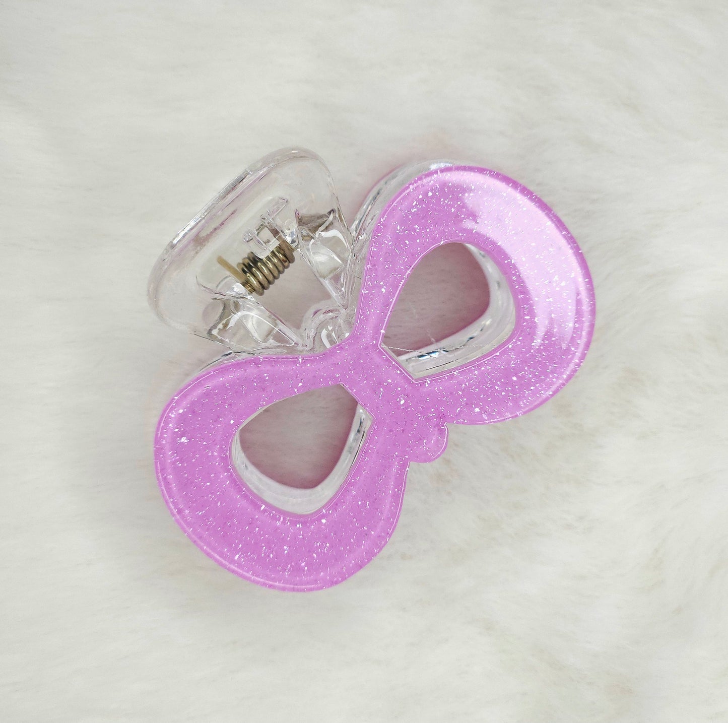 Lavender glitter pop bow hair claw clip with sparkling finish, stylish and elegant accessory for securing hair.