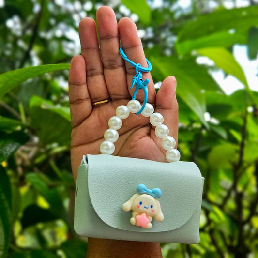 Light blue pouch with a cartoon character held by a hand against a green leafy background