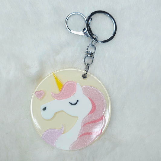 Keychain with a unicorn design on a light gray background