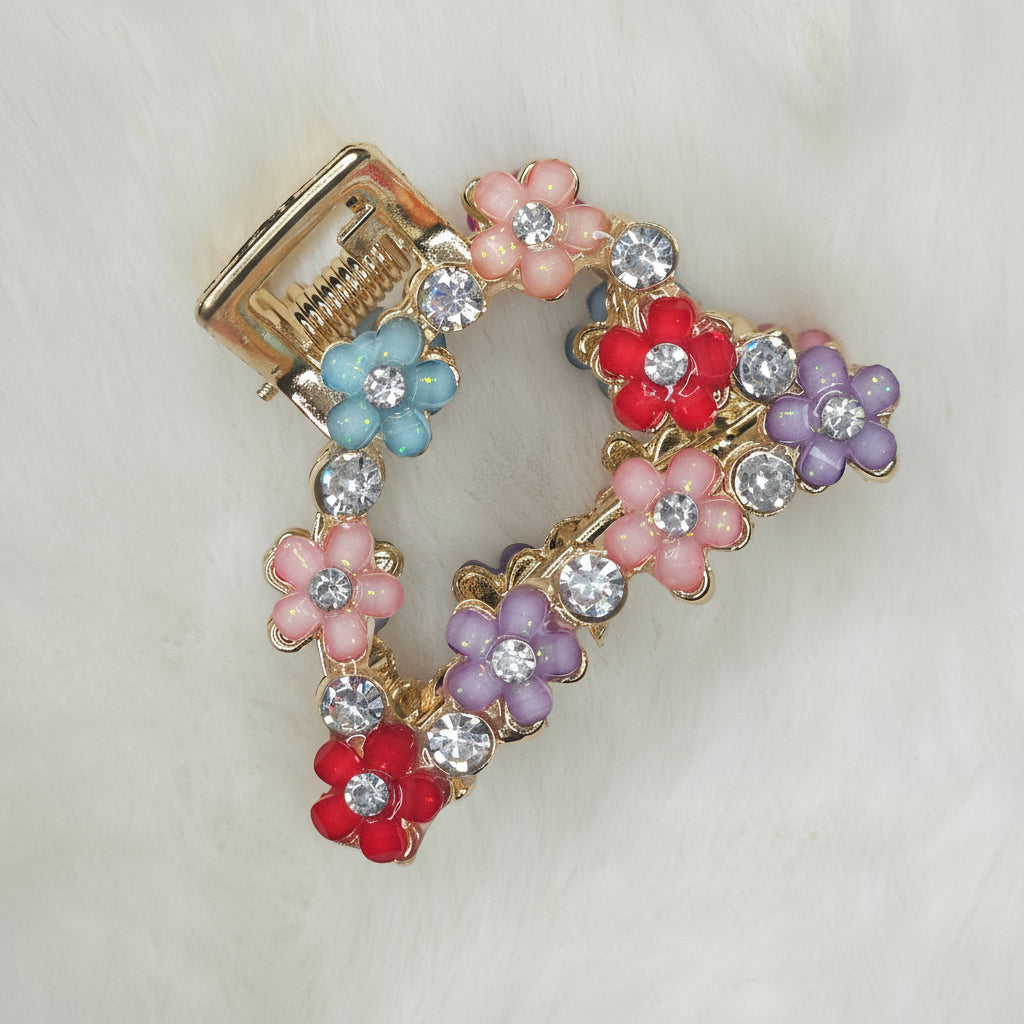 Decorative hair clip with colorful flowers and crystals on a white background
