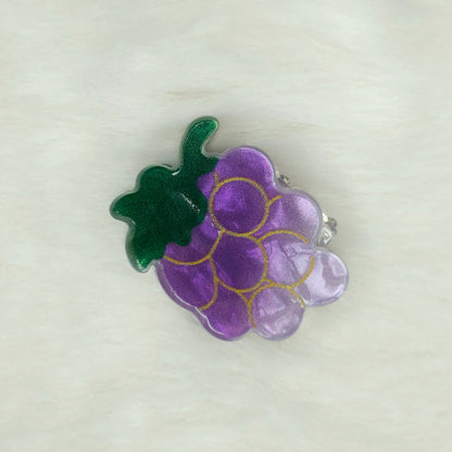 Purple grape cluster hair claw clip on a white background