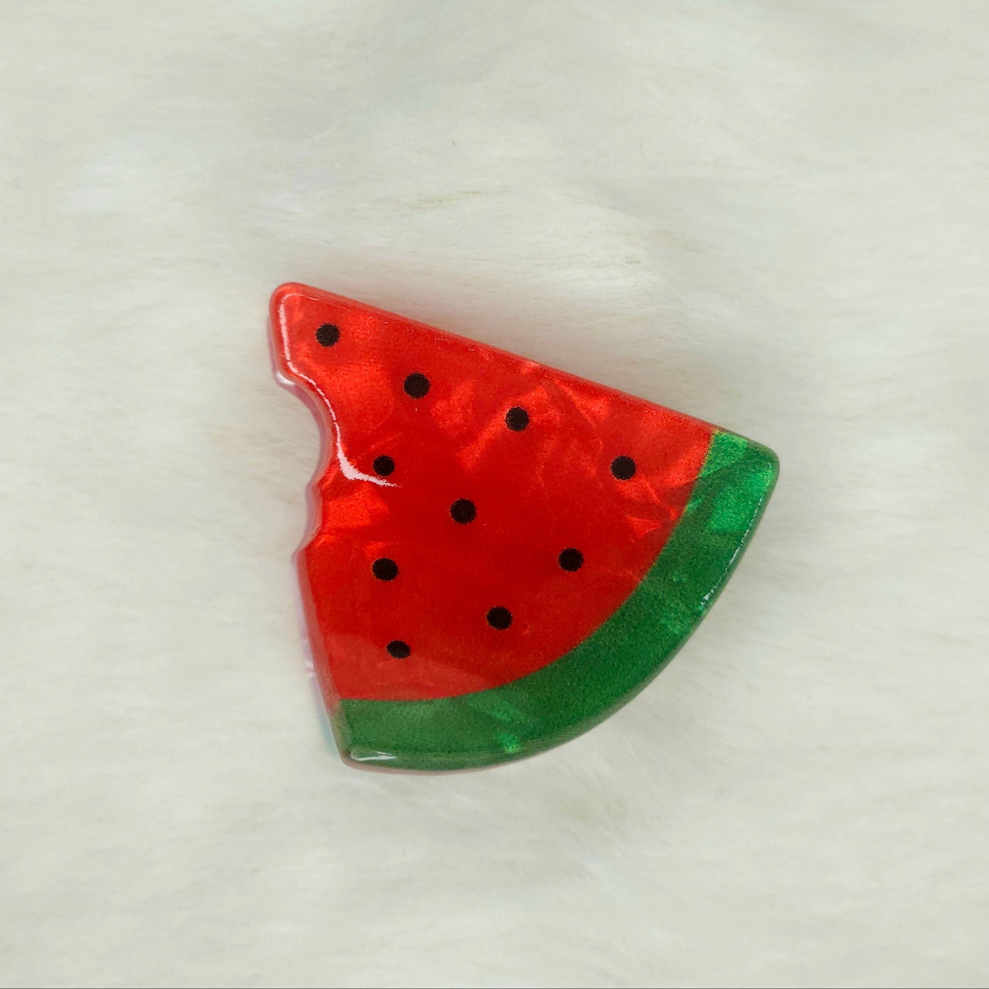 Watermelon slice-shaped acrylic hair claw clip on a white background