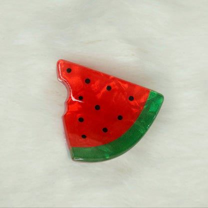 Watermelon slice-shaped acrylic hair claw clip on a white background