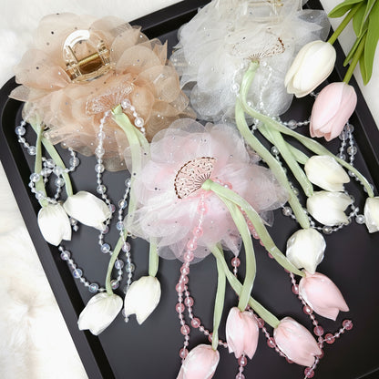 Decorative floral hair claw with flowers and beads on a black tray