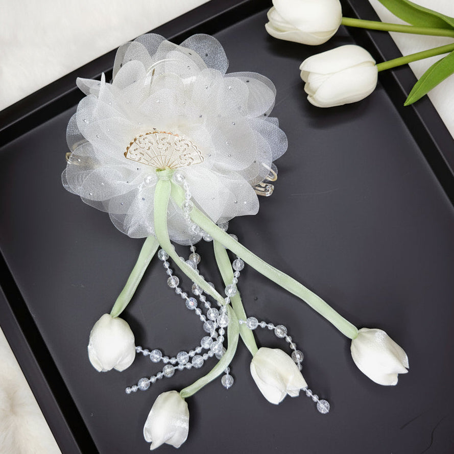 Decorative flower hair claw with white tulips on a black tray