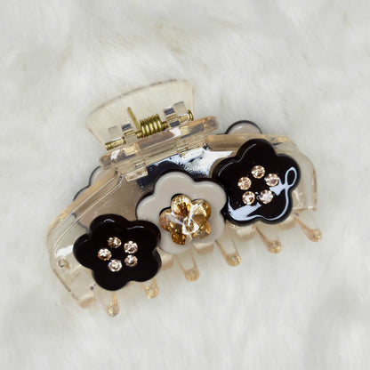Hair clip with floral designs and rhinestones on a white background