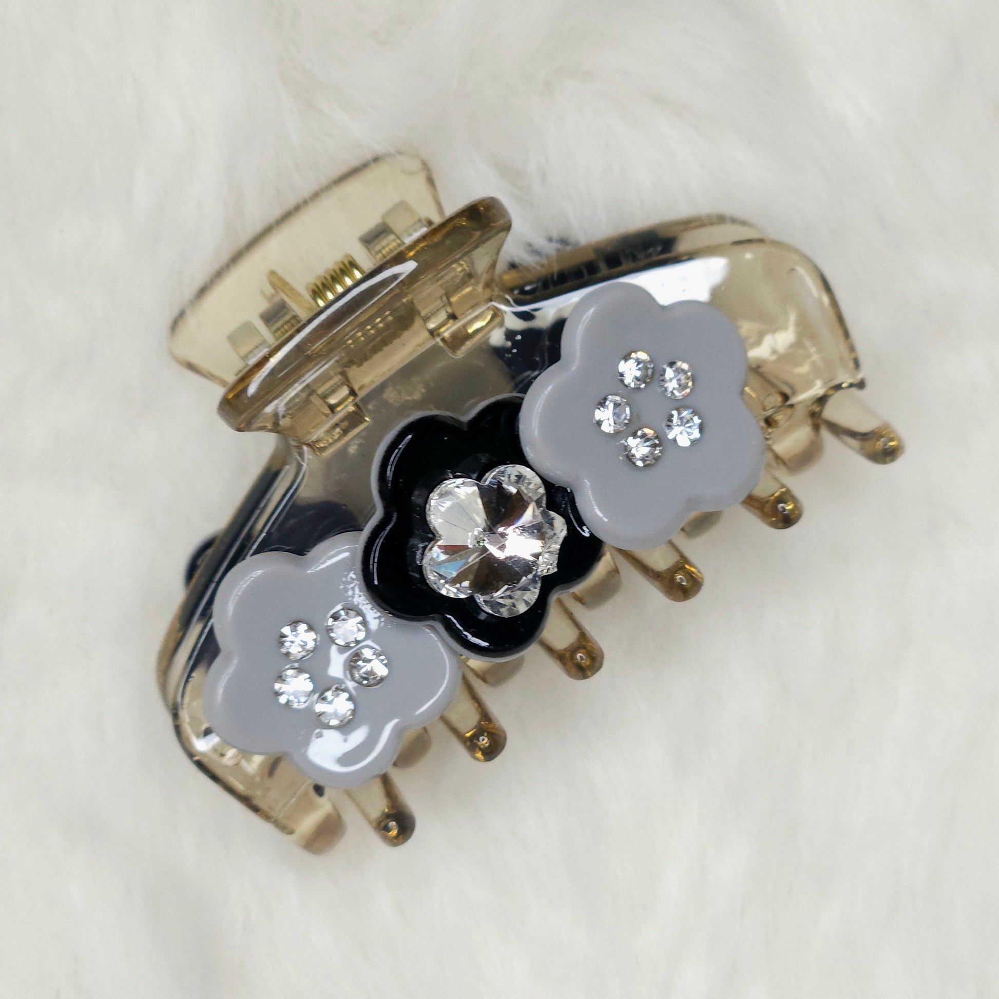 Hair clip with floral design and crystals on a white background