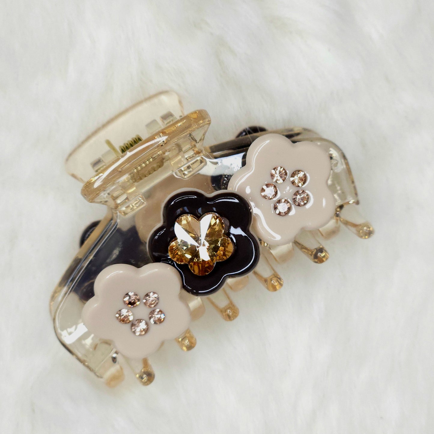 Decorative hair clip with floral design on a white background