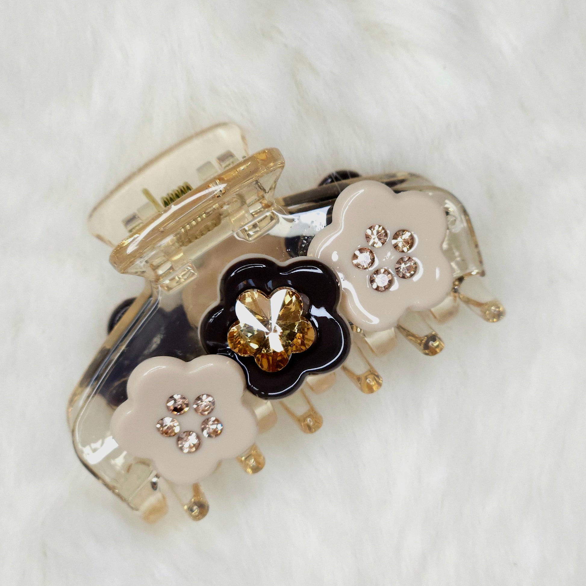 Decorative hair clip with floral design on a white background