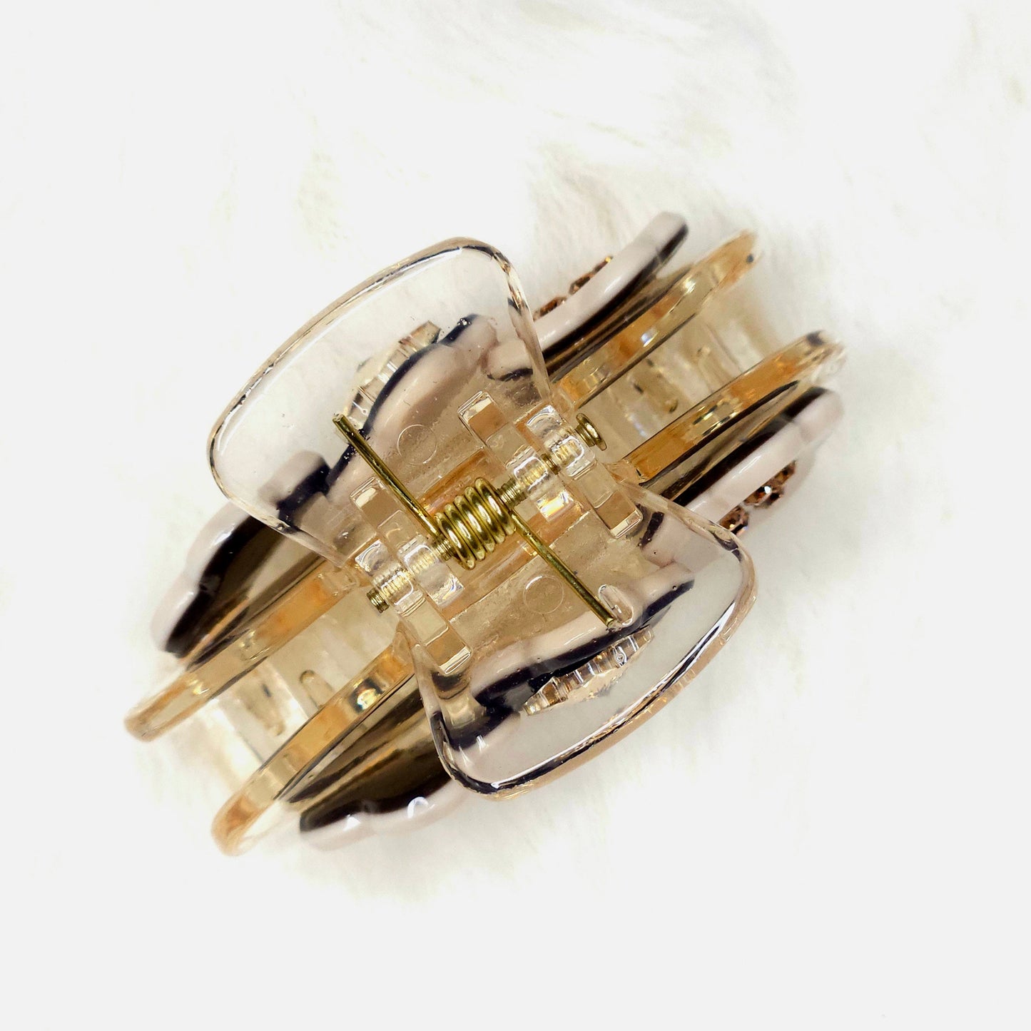 Gold and silver hair claw on a white background