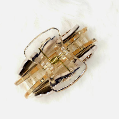 Gold and silver hair claw on a white background