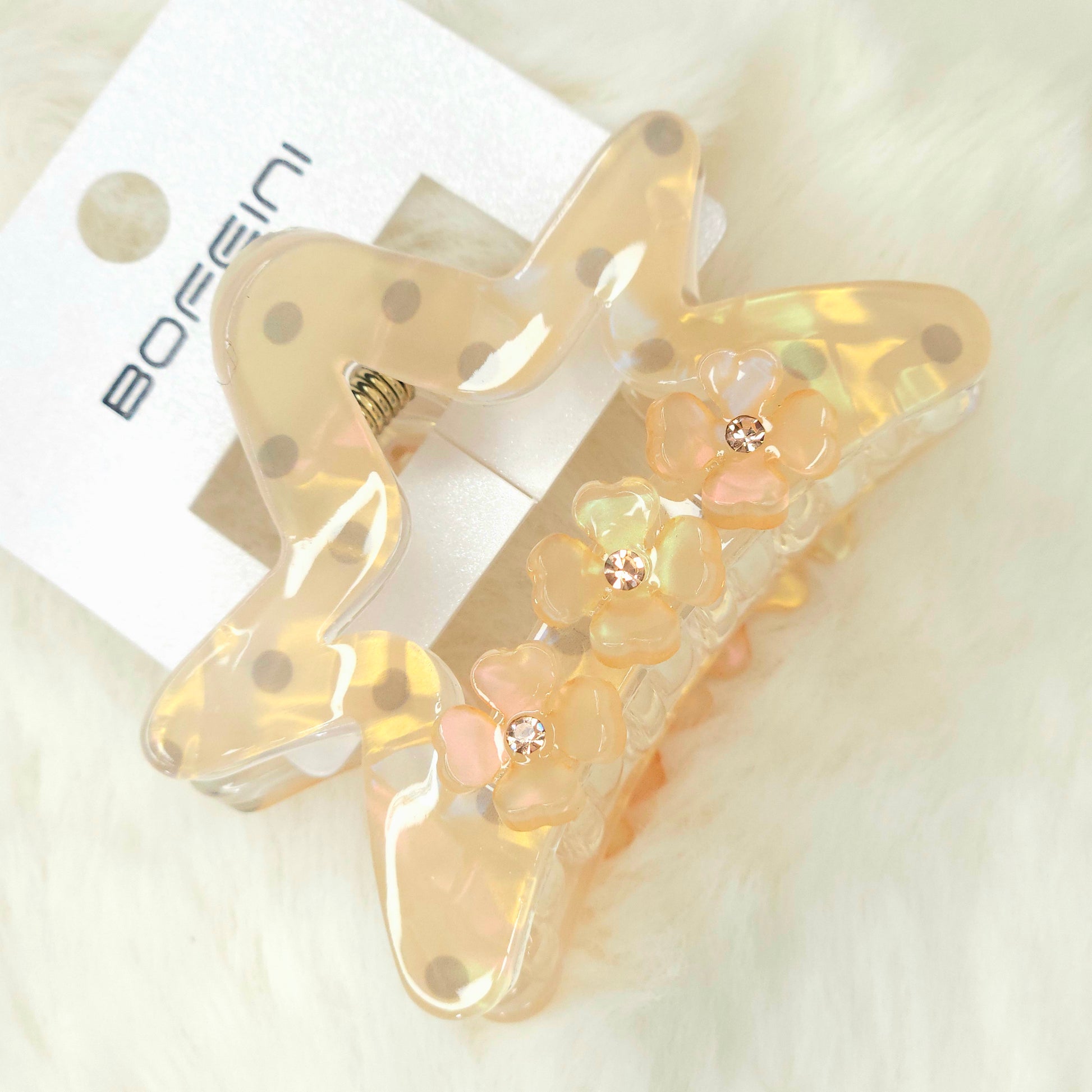 Decorative hair clip with floral details on a white background