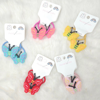 Colorful butterfly-shaped hair ties on white cards with a plain background