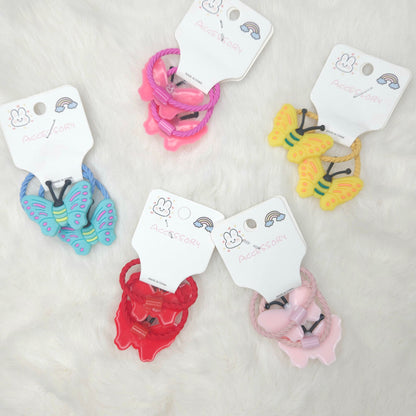 Colorful hair ties with butterfly designs on white tags against a light gray background