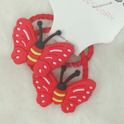 Red butterfly-shaped hair ties on a white background
