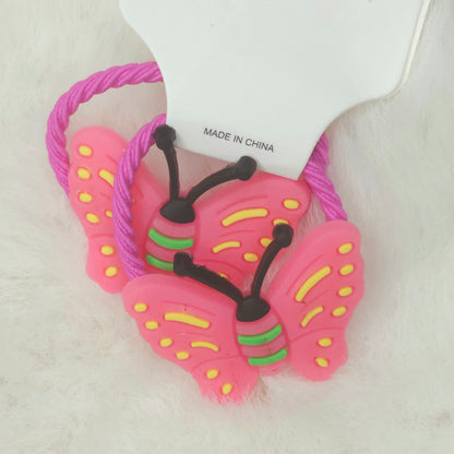 Pink butterfly-shaped hair ties with a visible 'Made in China' label on a white background