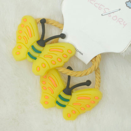 Yellow butterfly-shaped hair ties with a white tag on a light background
