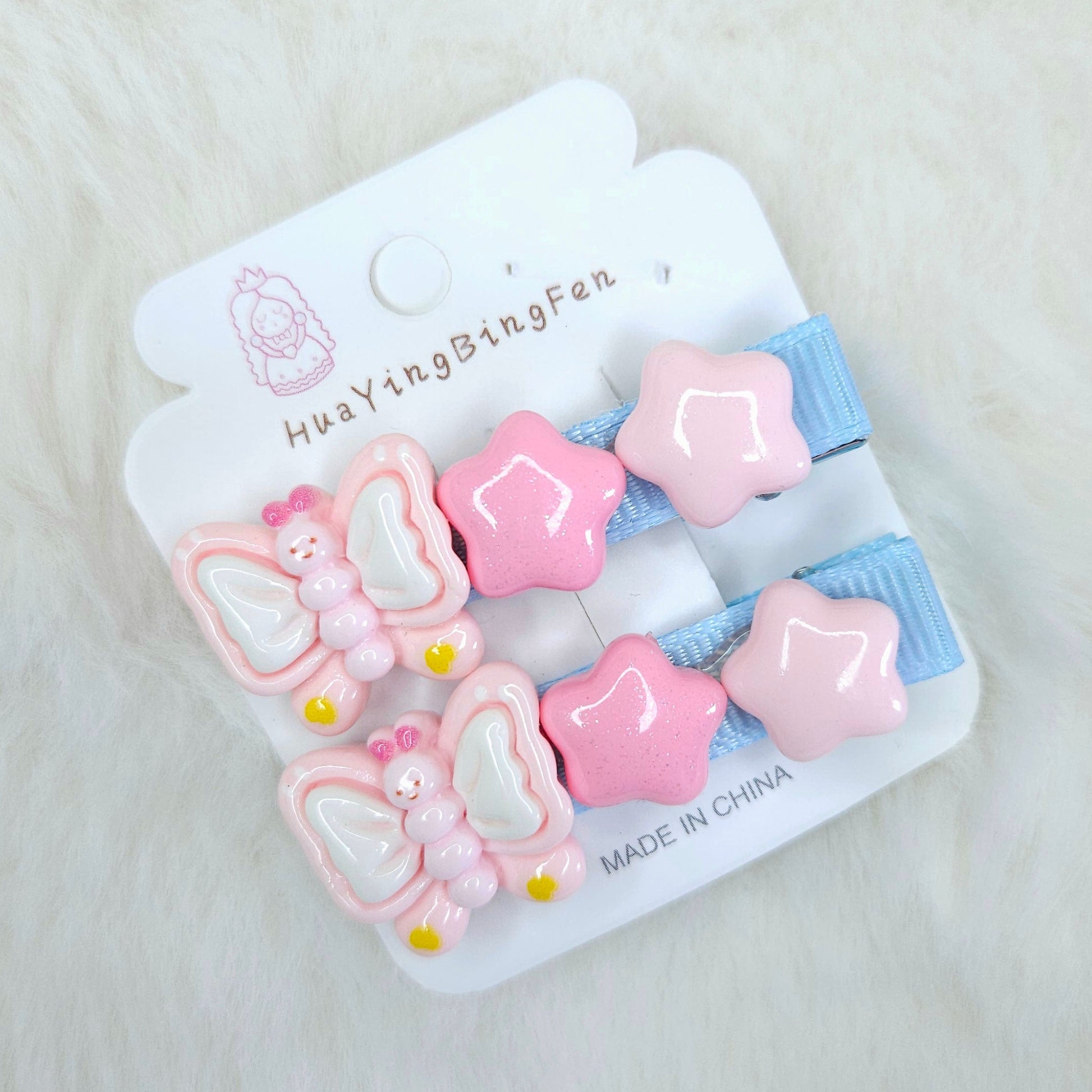 Set of pink and blue hair clips on a white card with 'HuaYingBingFen' branding.