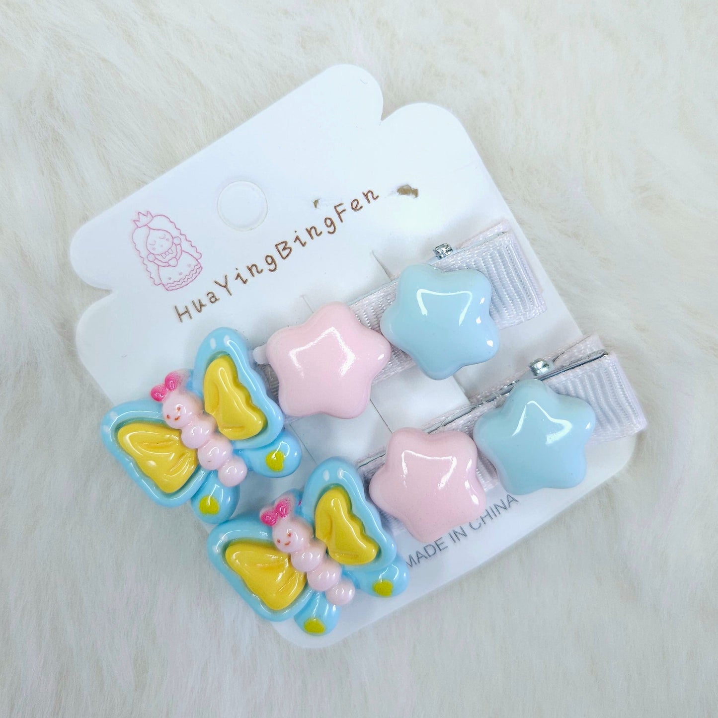 Packaged children's hair accessories with butterfly designs on a white background