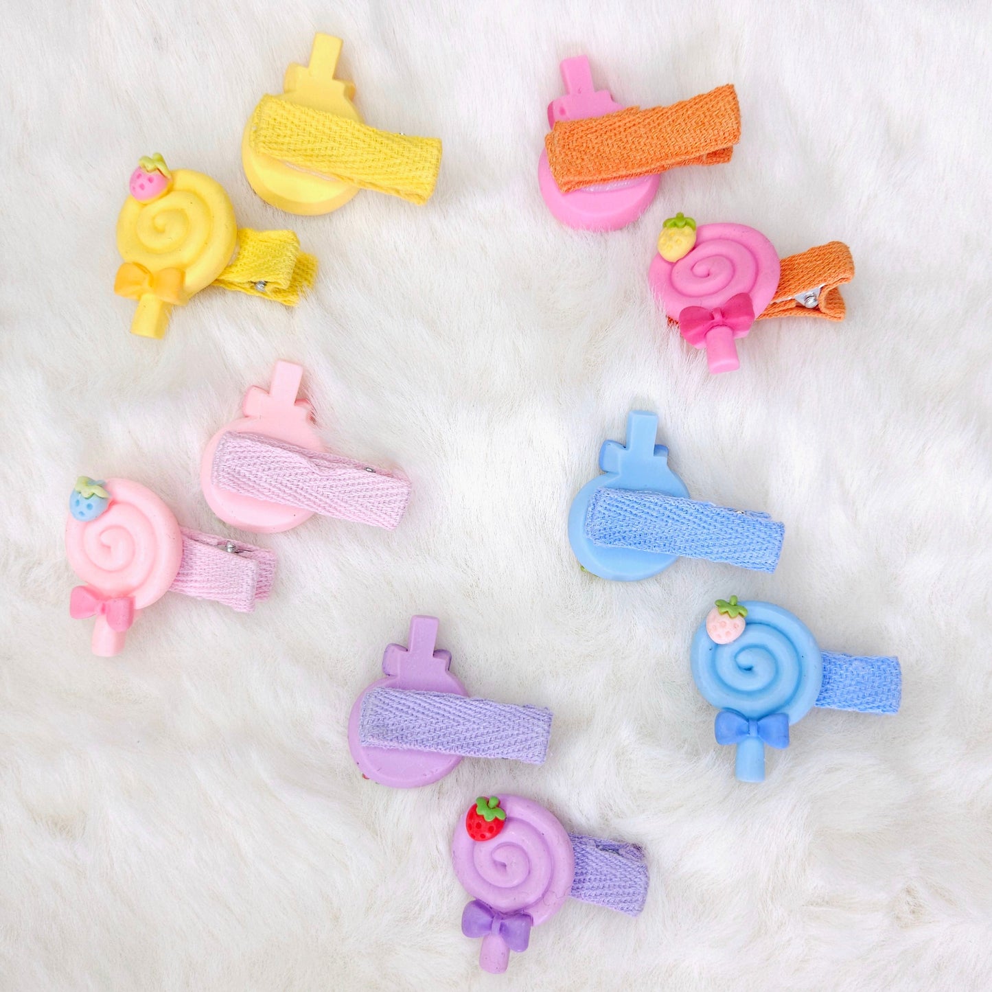 Colorful hair clips on a white fluffy background