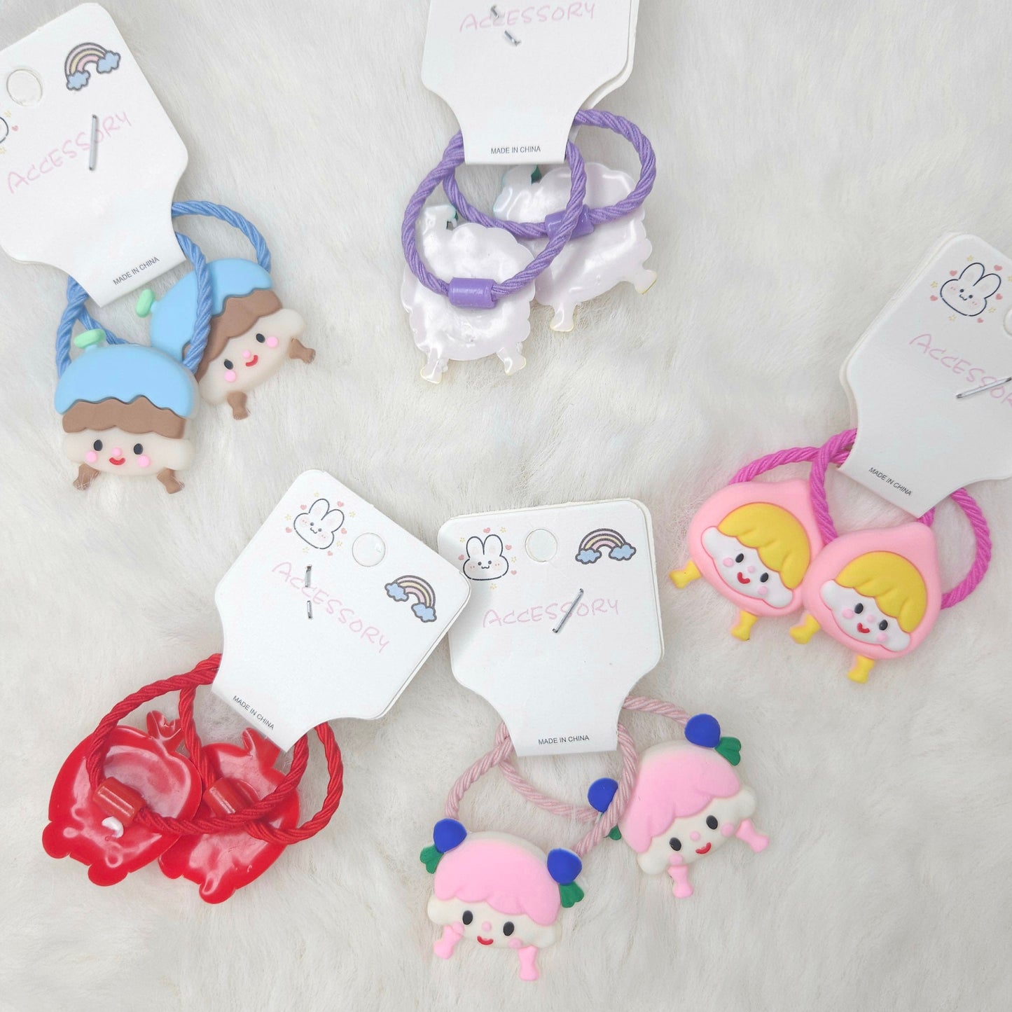 Set of colorful hair ties with cartoon characters on white background