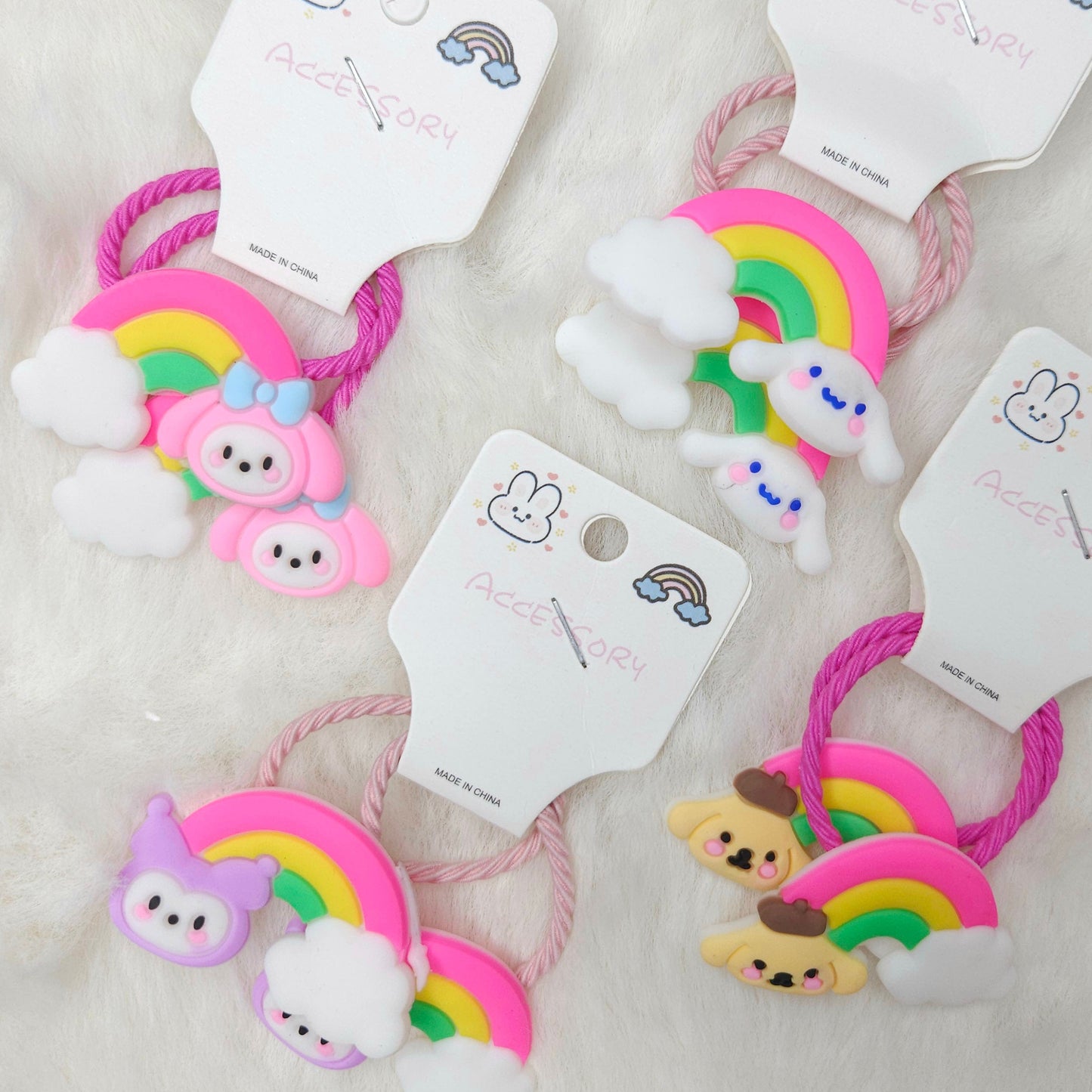 Set of colorful hair ties with cartoon characters on white cards.
