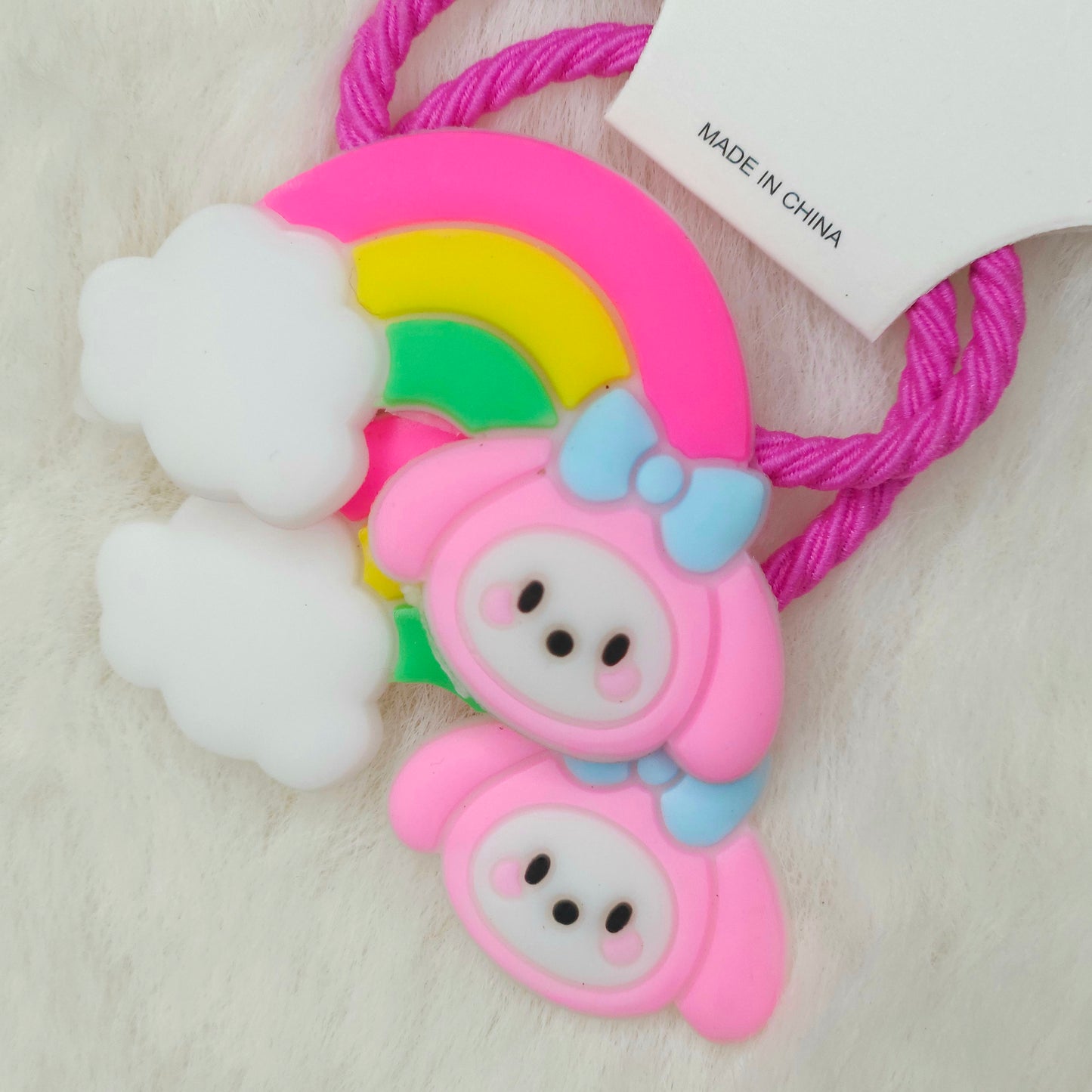 Colorful rubber band holder with cartoon character design on a light background