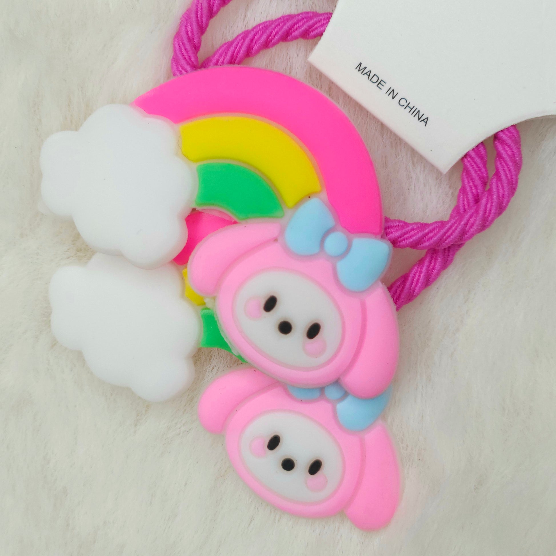 Colorful rubber band holder with cartoon character design on a light background