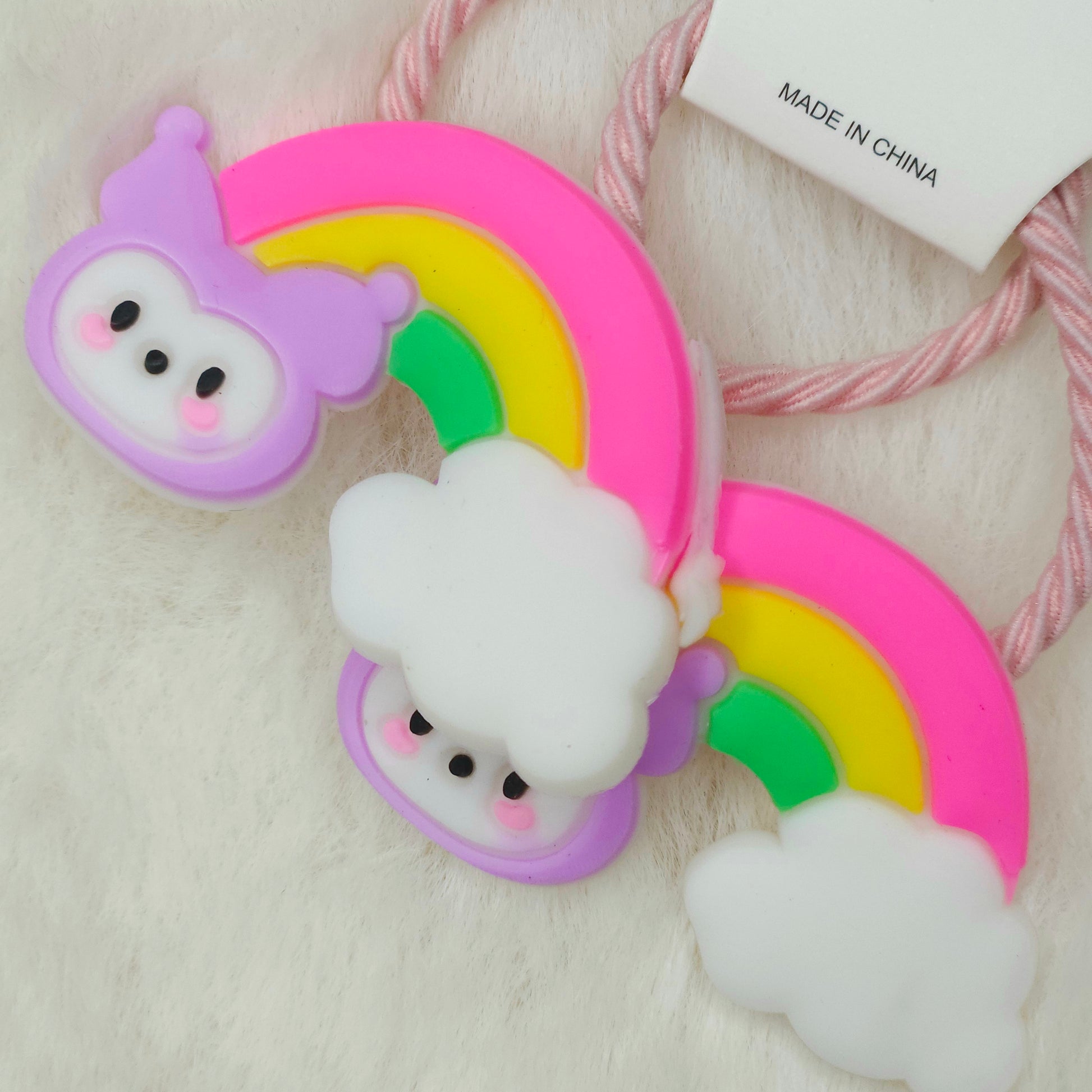 Silicone hair tie with cartoon character on a rainbow design, made in China label visible