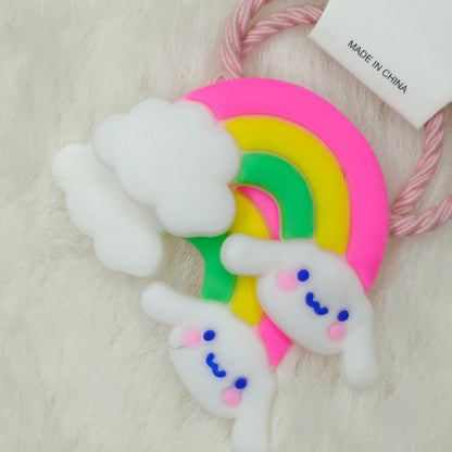 Colorful rainbow-shaped hair tie with cloud designs on a white background