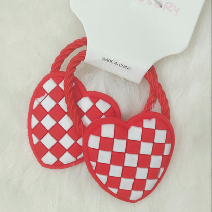 Red and white checkered heart-shaped earrings on a white background 