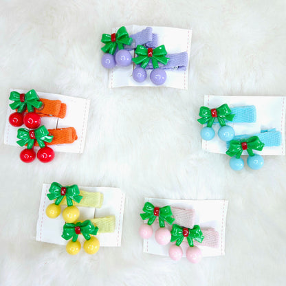 Set of colorful hair clips with bows and berries on a white background