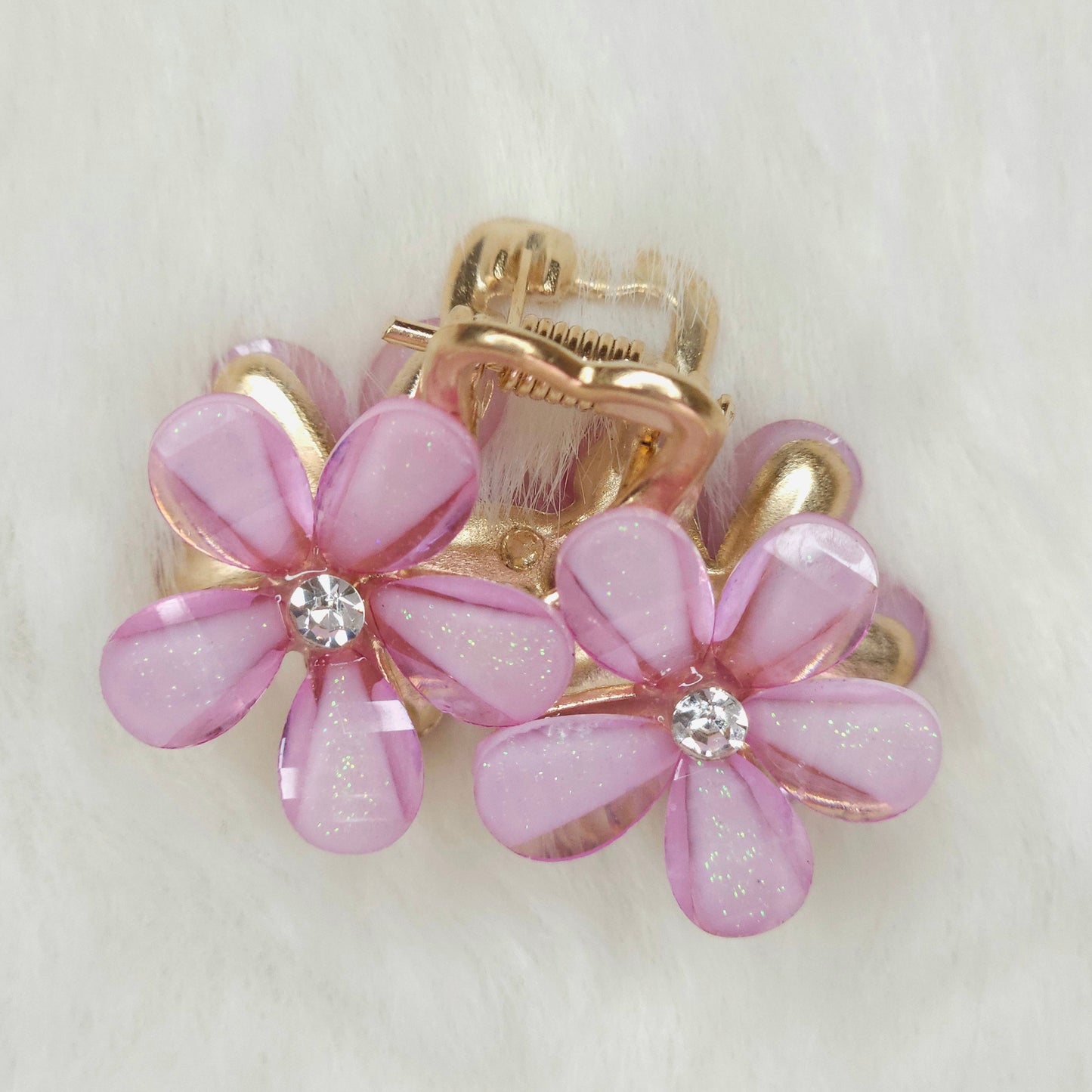 Hair clip with pink flower designs on a white background