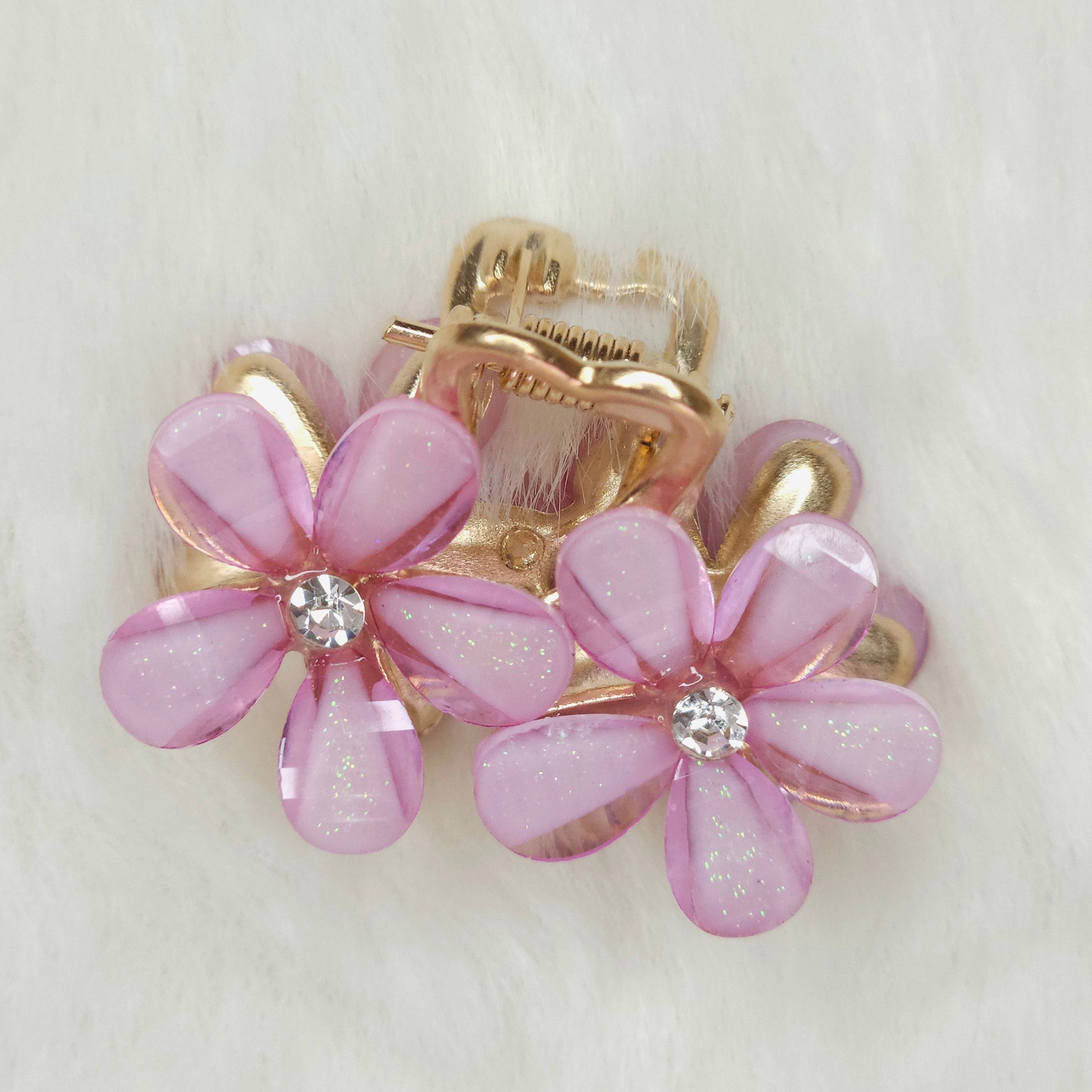 Hair clip with pink flower designs on a white background