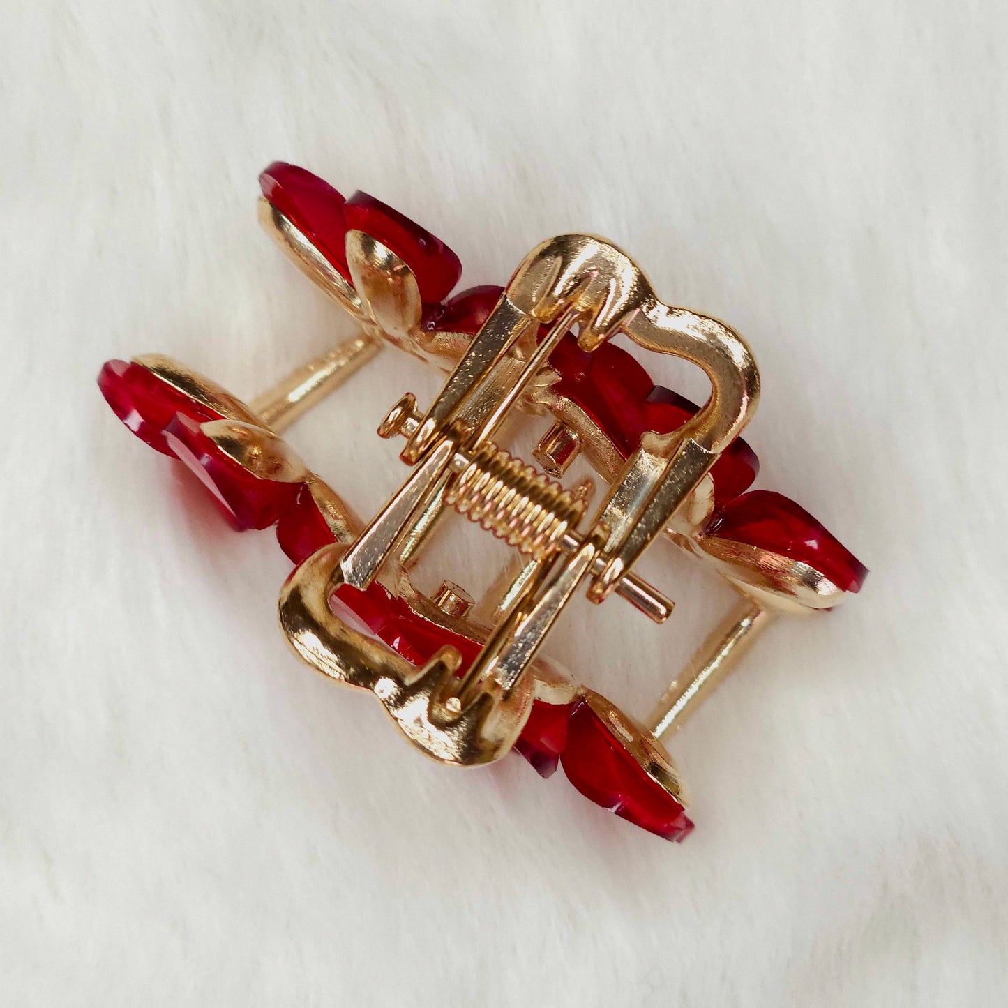 Red-Gold hair claw with red stones on a white background
