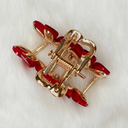 Red-Gold hair claw with red stones on a white background