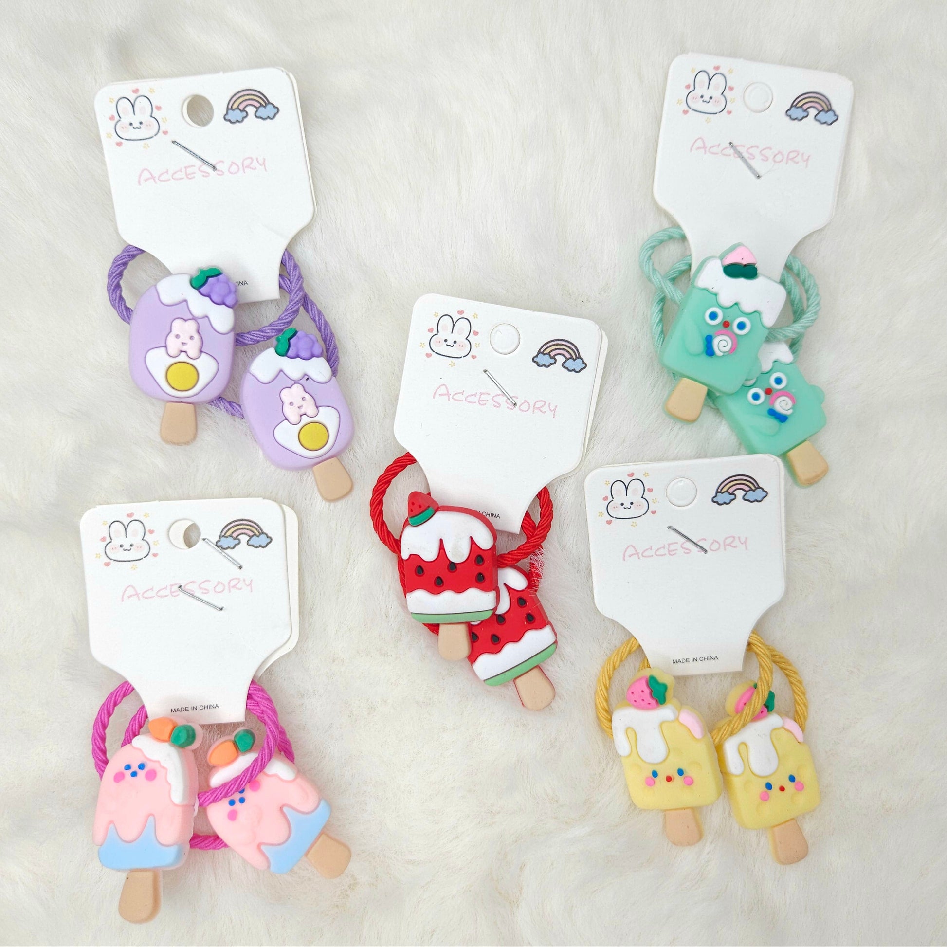 Set of colorful hair ties on cards with a plain background