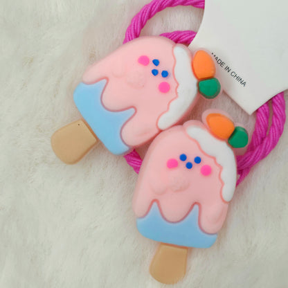 Ice cream popsicle-shaped hair tie with colorful details on a white background