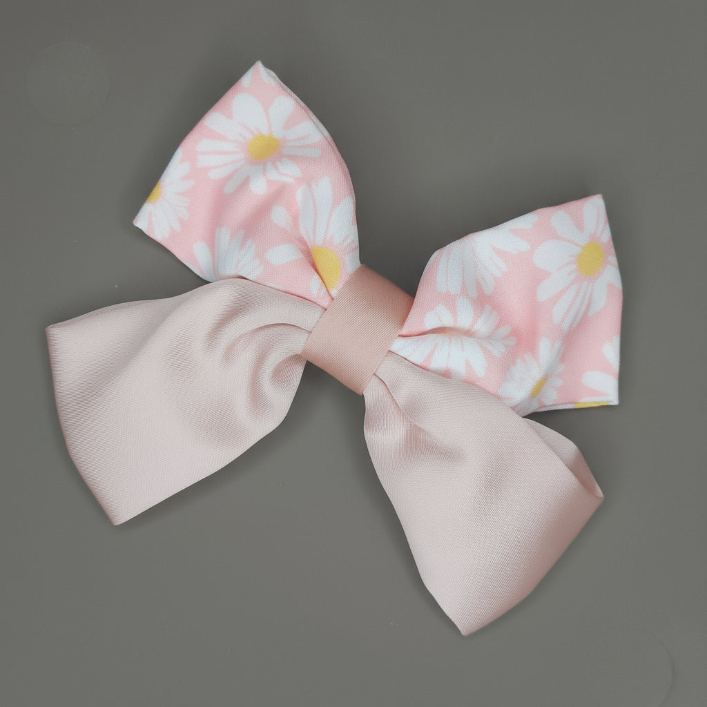Large fabric bow with floral pattern on a gray background