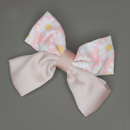 Large fabric bow with floral pattern on a gray background