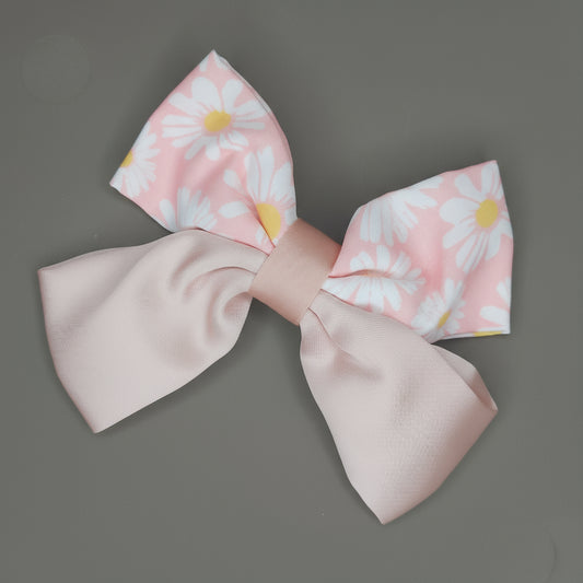 Large fabric bow with floral pattern on a gray background