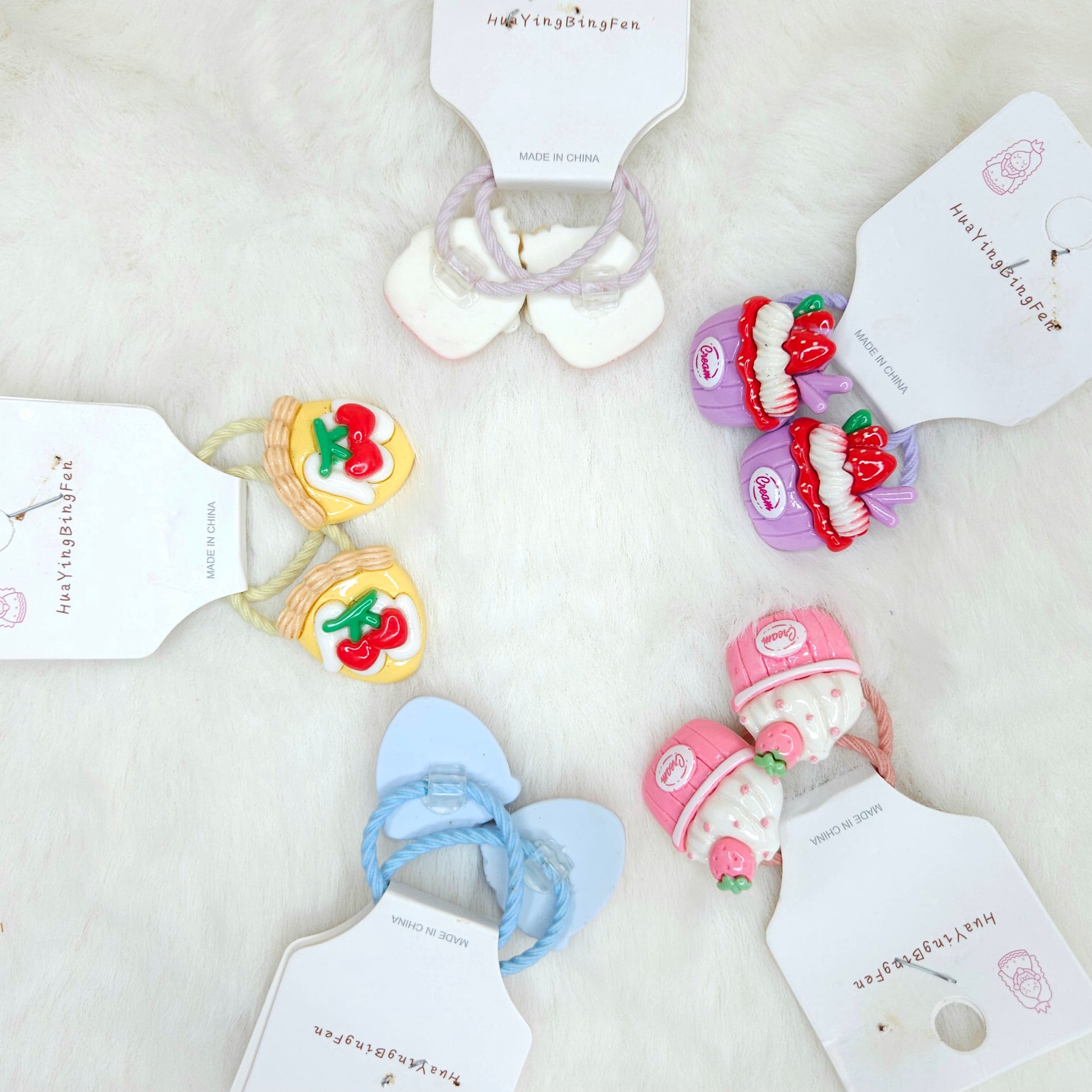 Set of colorful hair accessories with tags on a light background