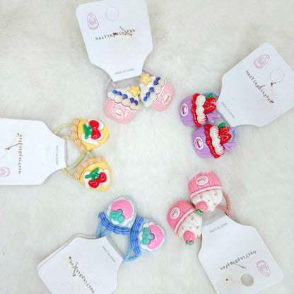 Colorful hair ties with decorative elements on a white background