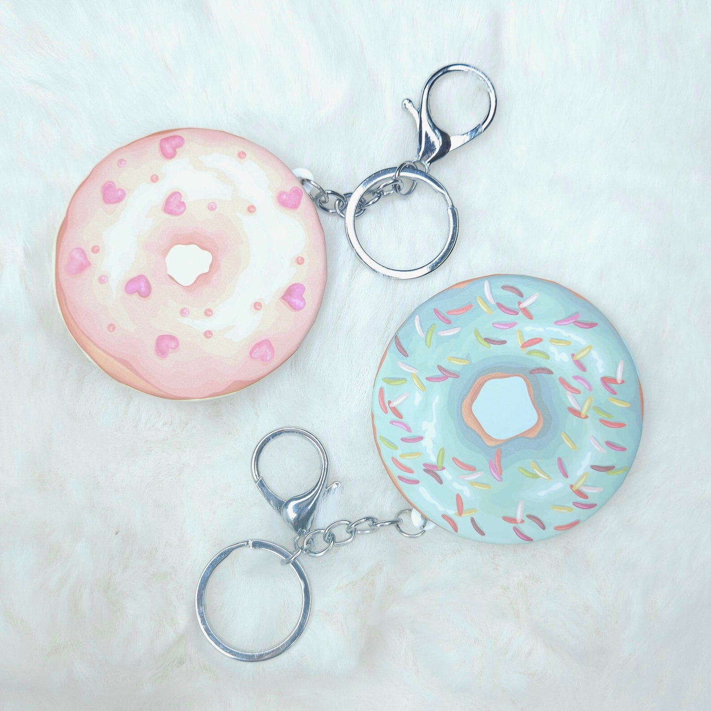 Two donut-shaped keychains on a white background