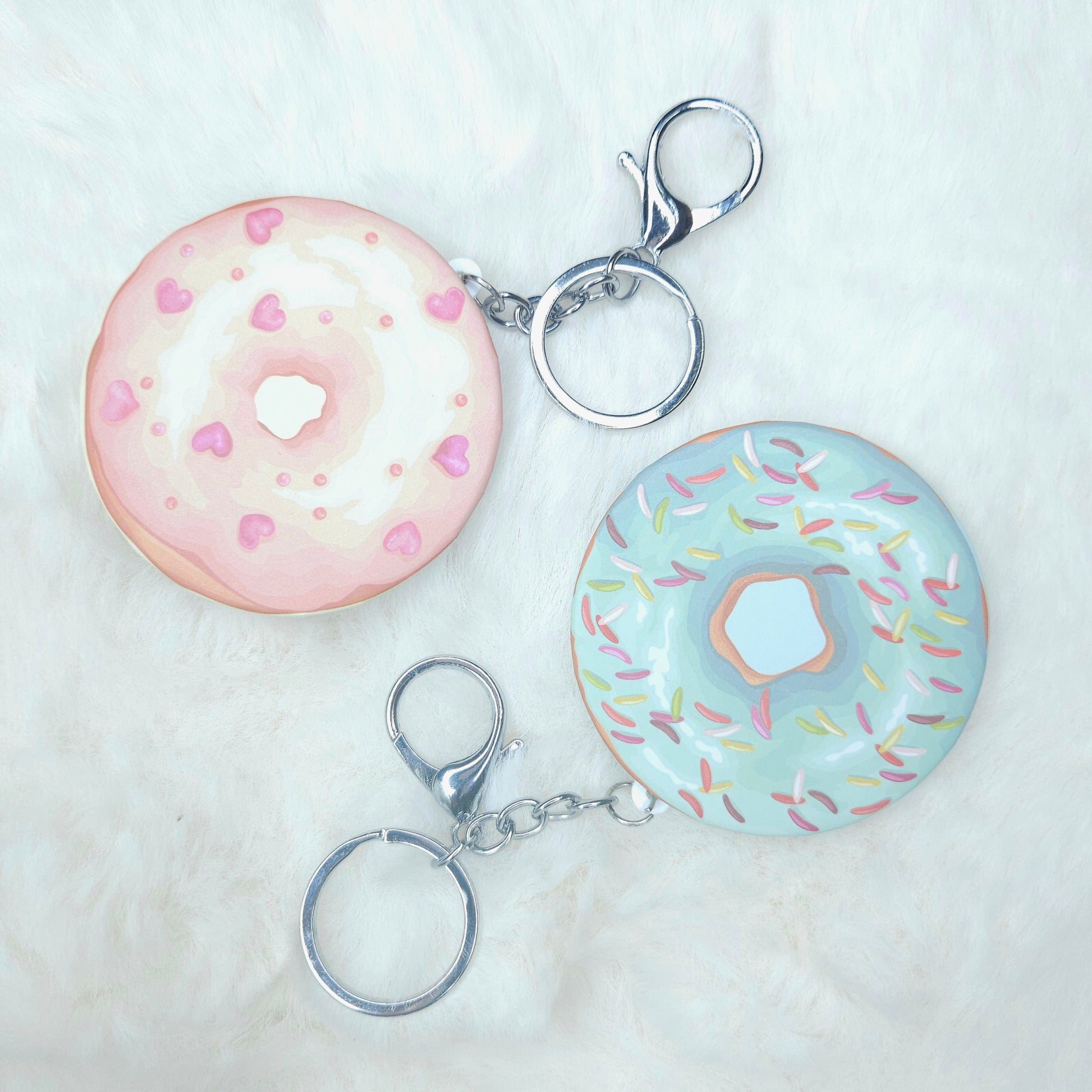 Two donut-shaped keychains on a white background