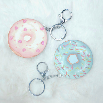 Two donut-shaped keychains on a white background