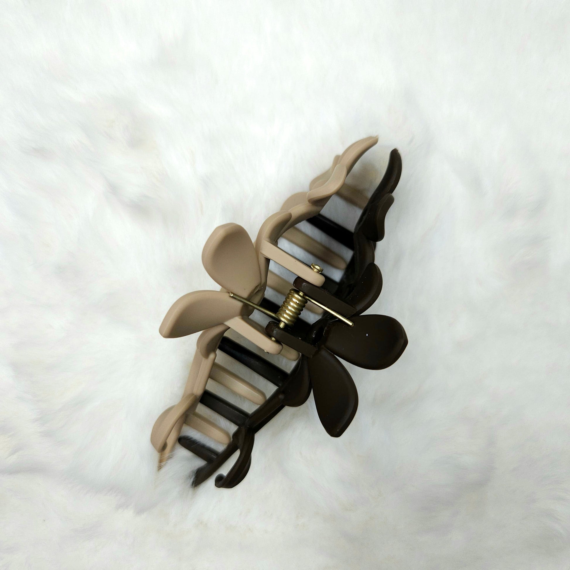 Hair clip with flowed design viewed from top angle on a white background