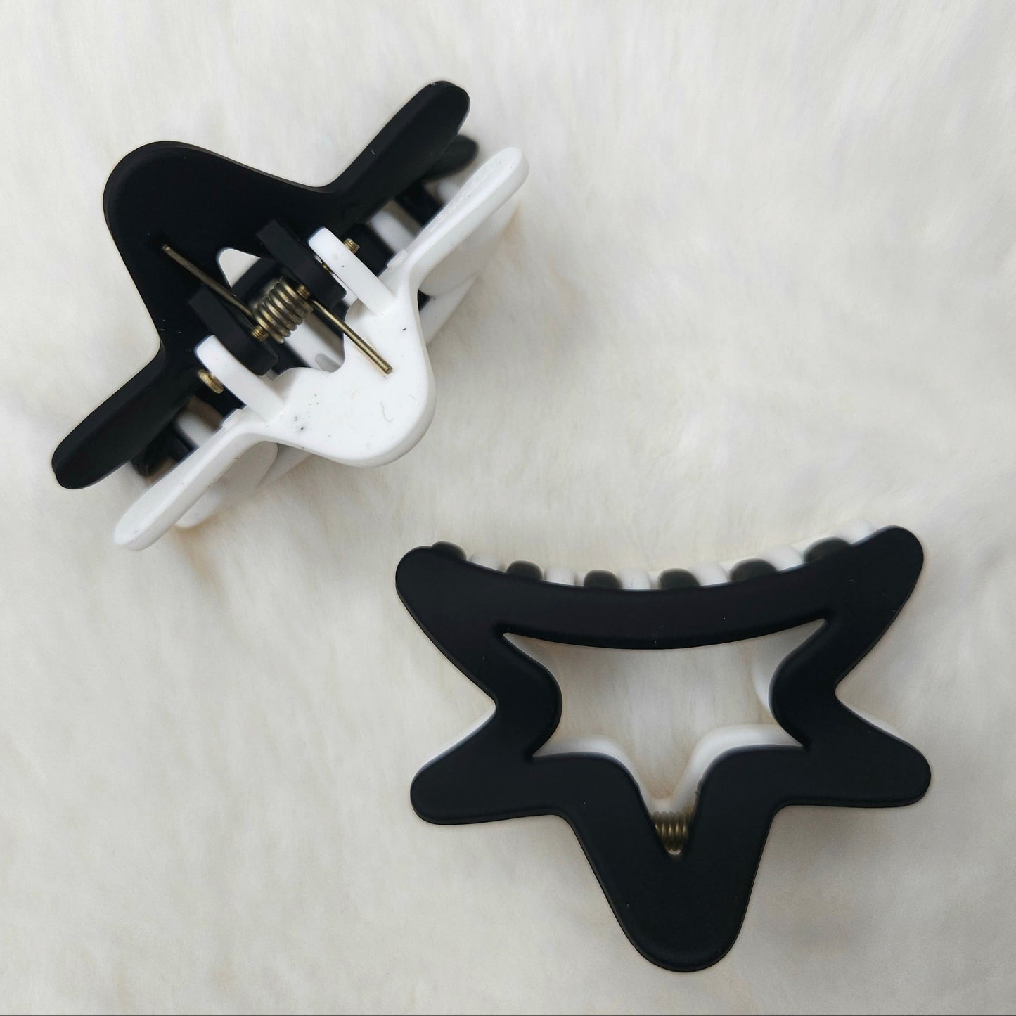 Black and white hair clips on a light gray background
