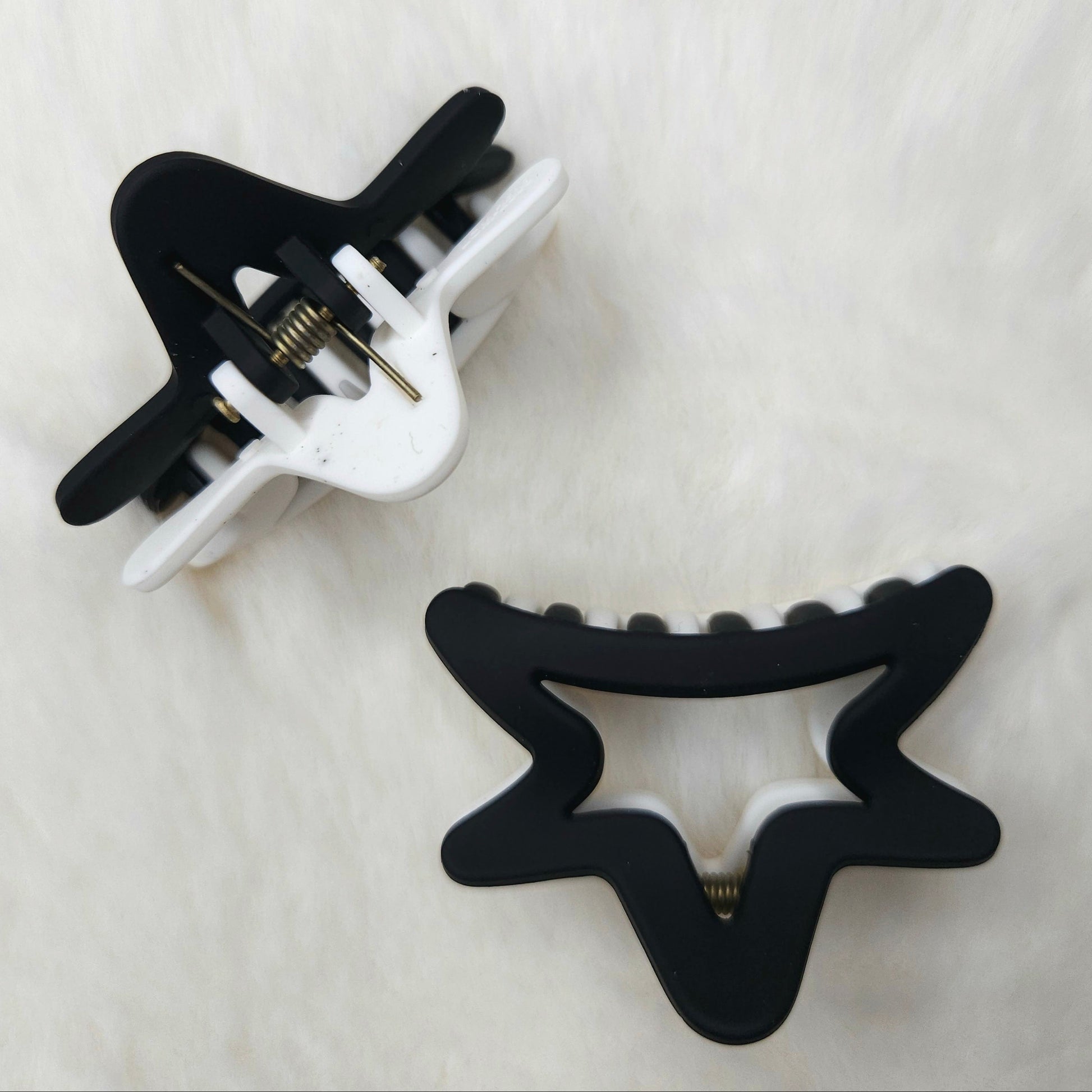 Black and white hair clips on a light gray background